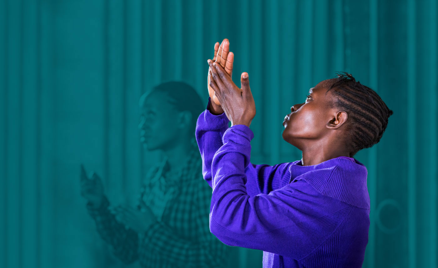 woman worshiping God through sign language